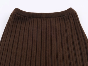 Detailed macro view of dark brown ribbed knit waistband with high elastic vertical texture