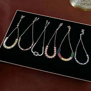 Adjustable cubic zirconia bracelets with colorful stones on black velvet display