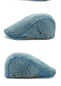 Detail of washed denim beret featuring hollow woven texture and adjustable bronze buckle