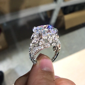Luxury oval cut cubic zirconia ring with hollow filigree design and silver finish
