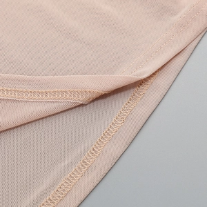 Detail of high neck mesh dress showing fine stitching and rhinestone mesh texture
