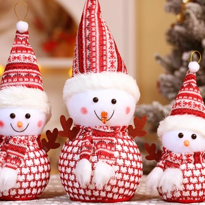 Detailed view of three plush Christmas snowmen set with knit hats and festive scarves