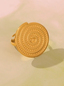 Macro shot of gold leaf texture ring with spiral patterns and small bead details
