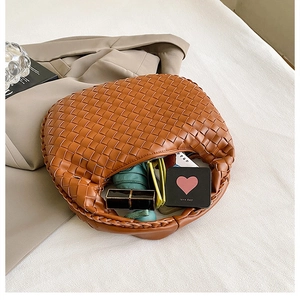 Close-up of brown woven hobo bag showing interior capacity with daily essentials