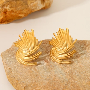 Golden sunburst fan stud earrings in stainless steel on a natural stone base