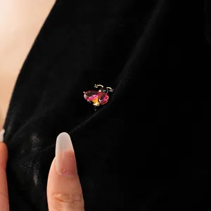 Luxury vintage bee brooch with gold plating, pink gemstones, and black enamel details