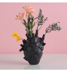 Detailed macro view of an anatomical heart vase with intricate vessel textures for flowers