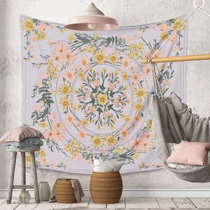 Detail of bohemian mandala tapestry with purple and yellow floral pattern on gray wall