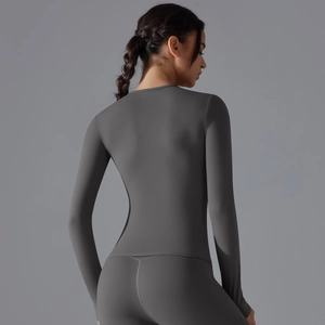 Detail view of charcoal grey high-stretch seamless yoga top and leggings on a model