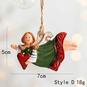 Detail of resin angel ornament with red heart and twine rope for Christmas tree