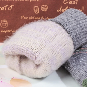 Close-up of thick thermal fleece lining on grey knitted winter gloves for warmth