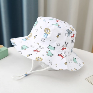Detail of a white cotton kids bucket hat with cute animal prints and adjustable chin strap