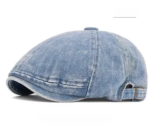 Detail view of washed denim flat cap showing the adjustable metal buckle and vintage texture