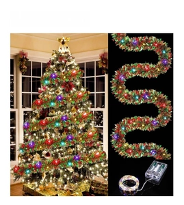 Detail of tricolor Christmas tinsel garland with warm LED copper wire lights for party decor