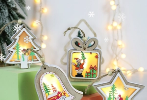 Close-up of lighted wooden Christmas ornaments featuring star and bell shapes with LED glow