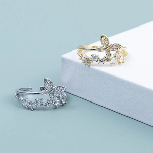 Detailed view of silver and gold double-layer butterfly rings with shimmering zircon accents