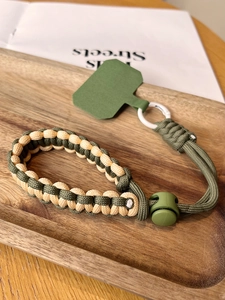 Detail of army green and beige woven phone lanyard with adjustable clip and connector