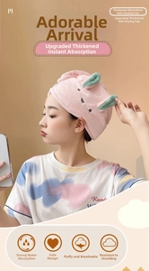 Detail of pink coral fleece hair towel featuring cute rabbit ears and soft texture