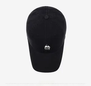 Top view of a black washed cotton baseball cap featuring detailed mountain embroidery