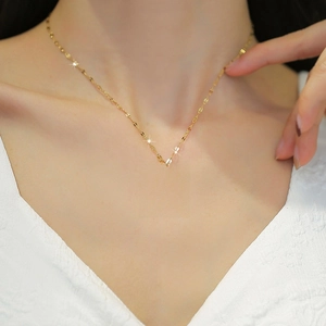 Minimalist gold titanium steel necklace with Xi character pendant on elegant model neck