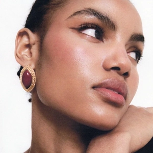 Vintage 18k gold plated stainless steel eye-shaped earrings with red agate stone on model