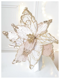 Close-up of glittery champagne poinsettia decoration in a minimalist white vase