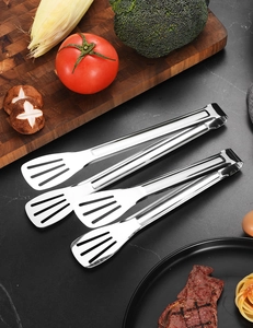 Macro shot of stainless steel food tongs with hollow head design on dark marble tabletop