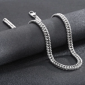 Detailed view of silver stainless steel Cuban link necklace on black display