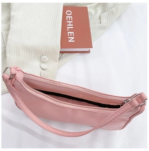Overhead view of a pink nylon hobo bag showing the black lining and spacious interior