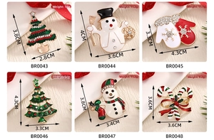 Detail view of six Christmas brooch styles featuring enamel trees, snowmen and candy canes