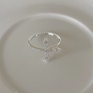 Geometric 925 sterling silver cross ring with sparkling cubic zirconia on gray tray