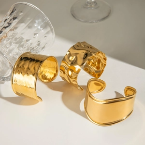 Three-piece gold irregular wide open bangles with hammered and smooth mirror textures