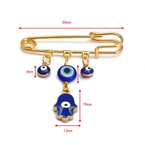 Detailed size chart for the gold safety pin brooch with Hamsa hand and evil eye charms