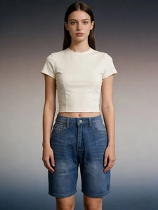 Close-up of white cropped T-shirt and high-waisted blue denim shorts set for women