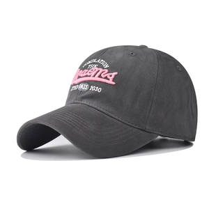 Detail of vintage washed cotton baseball cap featuring pink 3D embroidery and stitching