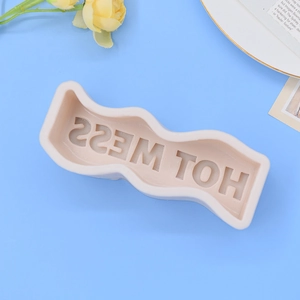 Pink silicone mold with wavy edges and HOT MESS text for scented candles and DIY crafts