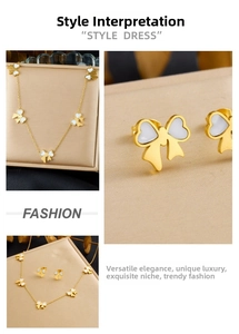 Detail view of gold-plated necklace and earrings set featuring white enamel bow designs