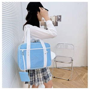 Sky blue heart-shaped JK uniform bag shown on model in a Japanese school style setting