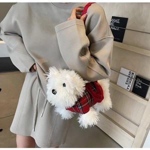 Plush white dog crossbody bag wearing a red plaid outfit on a lifestyle background