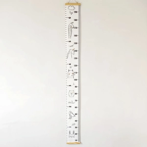Detail of wooden hanging height chart with minimalist animal illustrations on fabric