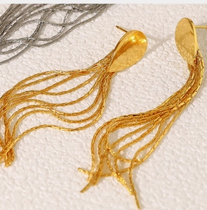 Macro shot of 18K gold plated stainless steel teardrop studs with long fringe chains
