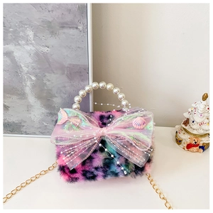 Detail of plush faux fur kid handbag with pearl handle and pink mesh bow decoration