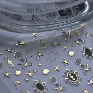 Macro shot of MS 628 ocean themed nail art stickers with golden seahorses and pearls