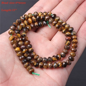 Macro shot of 4x6mm natural tiger eye gemstone faceted beads in a 15 inch strand