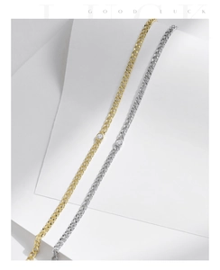 Detail of minimalist S925 silver and gold bracelets with central Moissanite stone