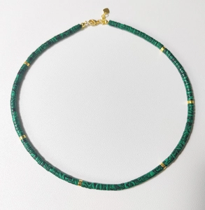 Detail of natural green malachite beaded necklace with gold spacers and heart pendant