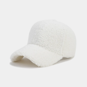 Detailed close-up of thick white lamb wool fabric on a minimalist winter baseball cap