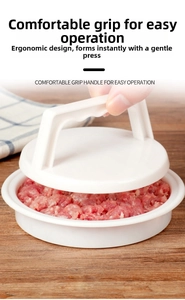 Ergonomic white plastic burger press making a round patty on a wooden table surface
