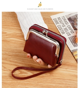 Detail of red vintage PU leather coin purse with metal kiss lock and side zipper strap