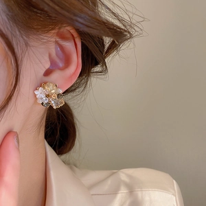 Vintage crystal flower geometric earrings with rhinestones worn by a model in profile view